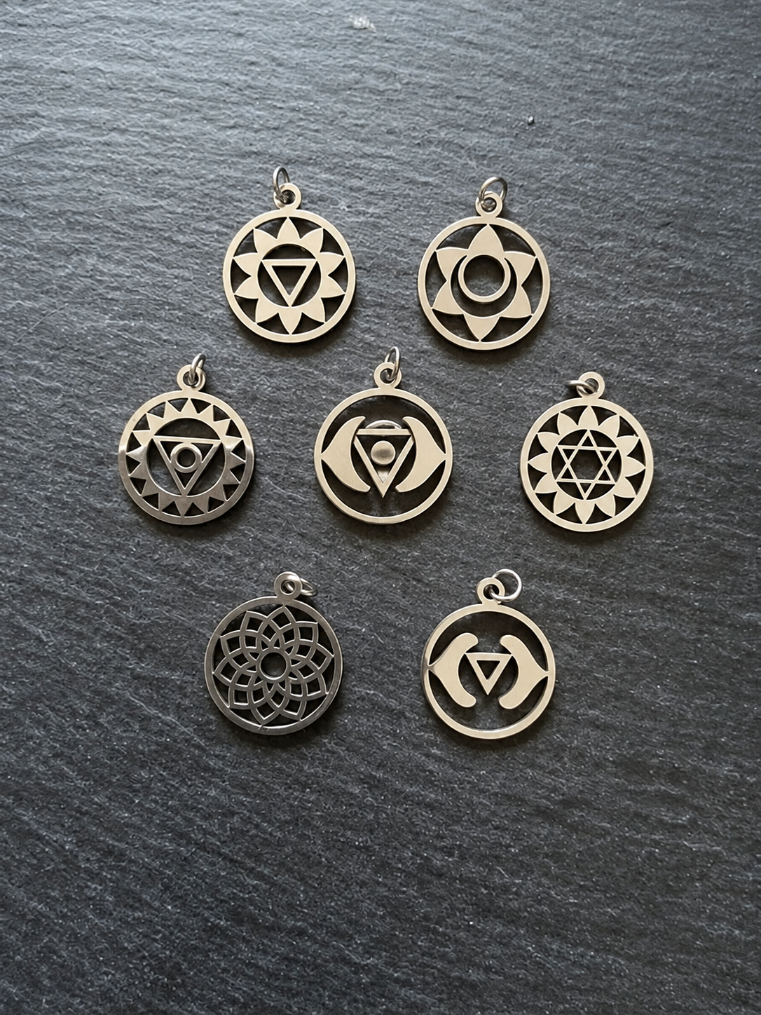 Seven Chakra Charms on Dark Slate